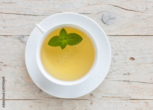 A cup of green tea on the wooden background