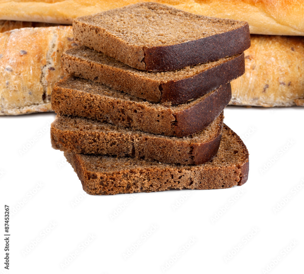 Sliced rye bread and two loaves of wheat flour Sliced rye bread and two loaves of wheat flour