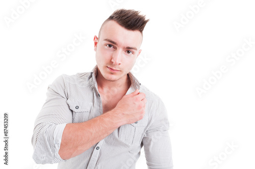 Yound and handsome man touching the shirt collar photo