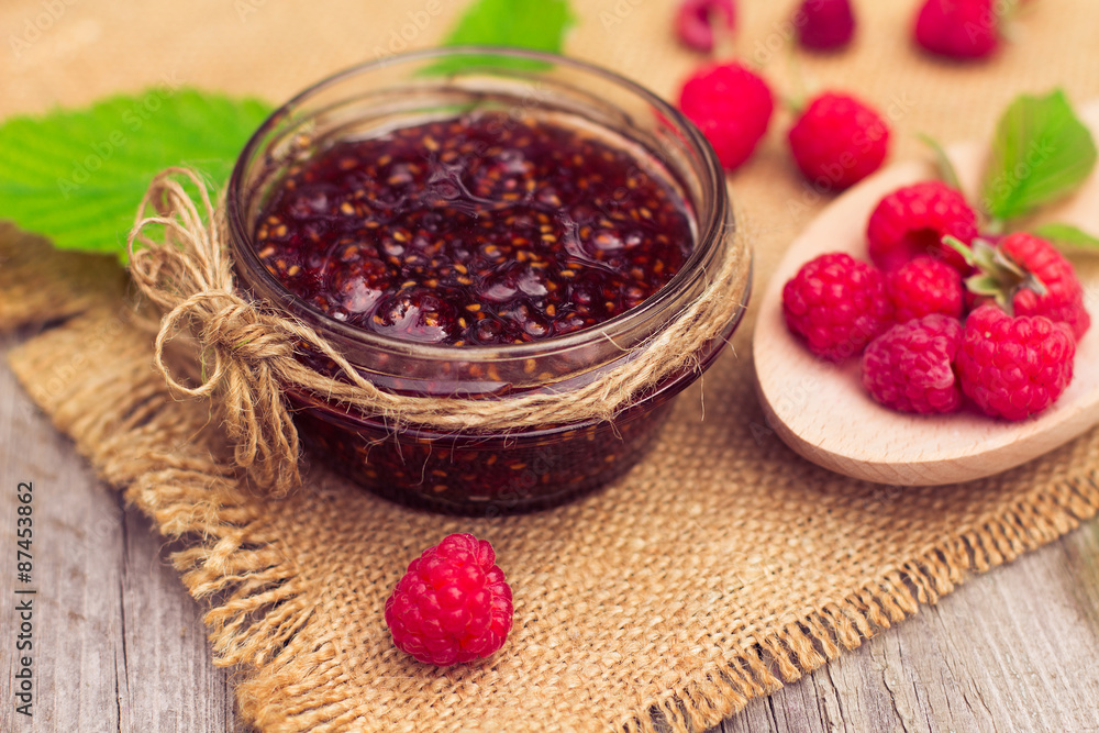 Fresh raspberries and jam on wooden table Fresh raspberries and jam on wooden table