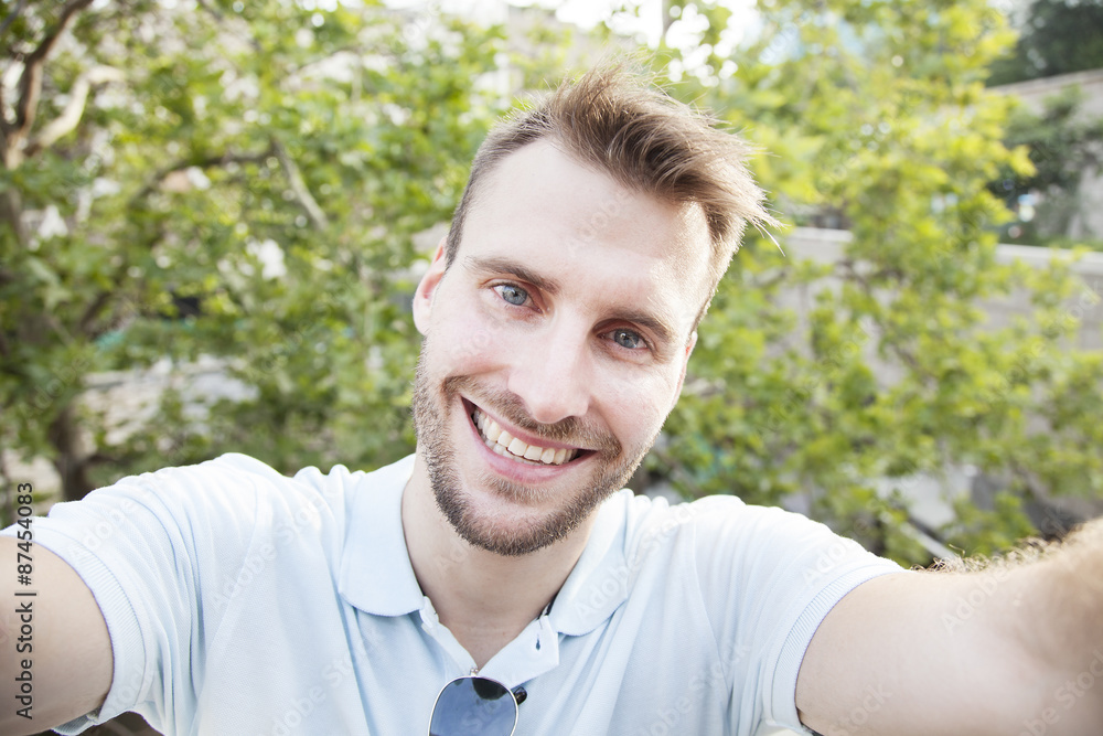 Selfie man taking self portrait. Smiling Selfie man taking self portrait. Smiling
