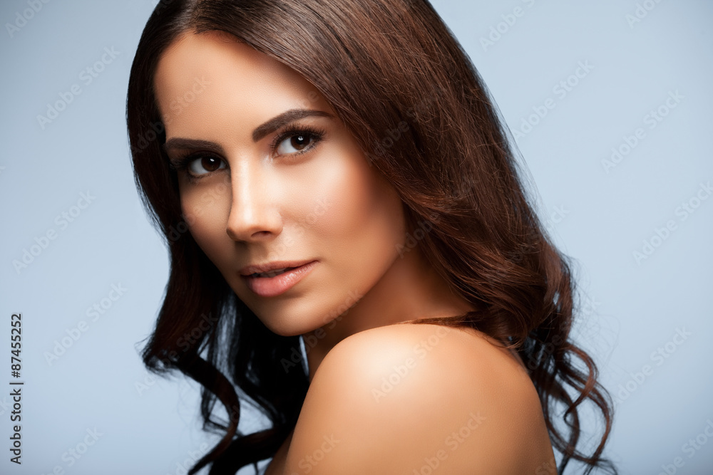portrait of beautiful young woman with naked shoulders, on grey portrait of beautiful young woman with naked shoulders, on grey