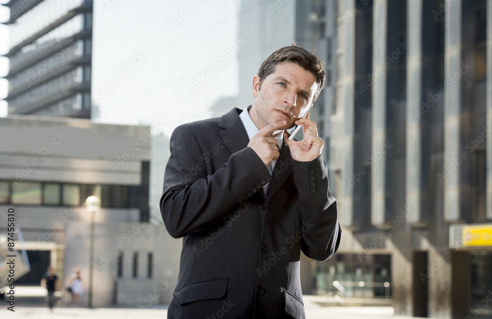 young attractive businessman talking on mobile phone outdoors young attractive businessman talking on mobile phone outdoors
