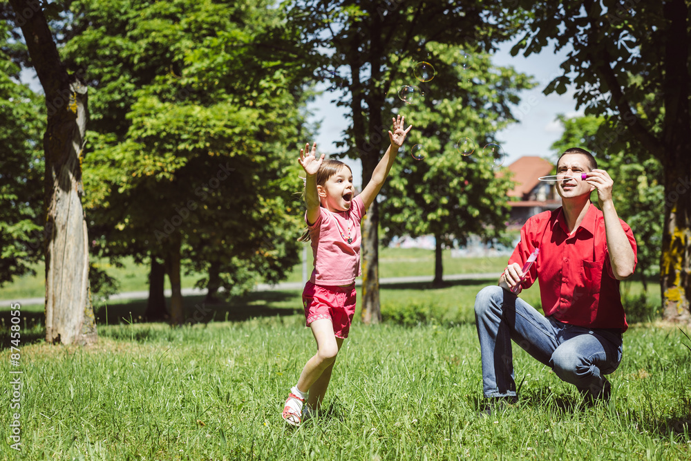 Dad and his daughter are making bubbles Dad and his daughter are making bubbles