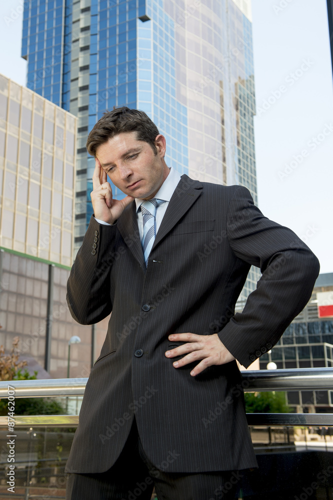young exhausted and worried businessman standing outdoors in stress young exhausted and worried businessman standing outdoors in stress
