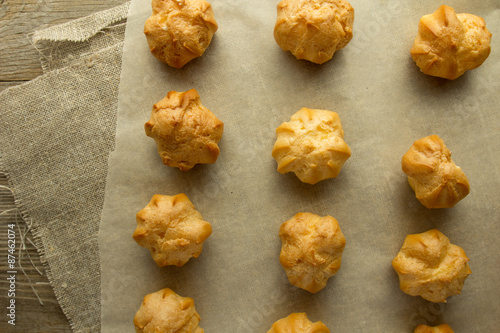 Profiteroles on cooking paper top view