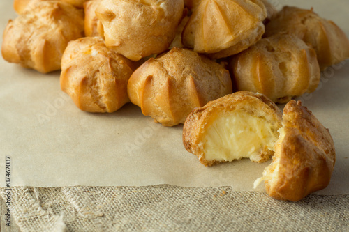 Cream puffs on cooking paper