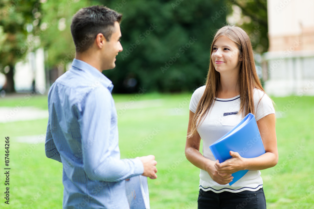 Foto Stock Couple of students talking together Adobe Stock