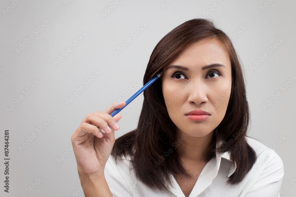 Young businesswoman thinking about an idea Young businesswoman thinking about an idea