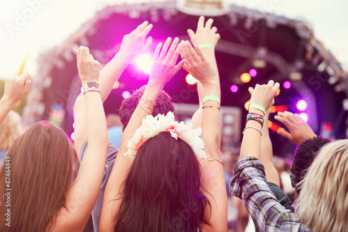 Audience with hands in the air at a music festival