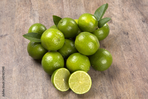 Fresh citrus lime with mint close up on wooden background