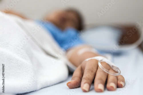 Focus on the hand of a patient in hospital ward