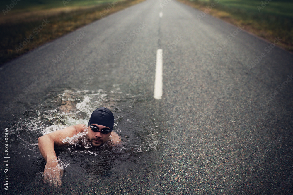 Strong Man Swim On Asphalt Road - obrazy, fototapety, plakaty 