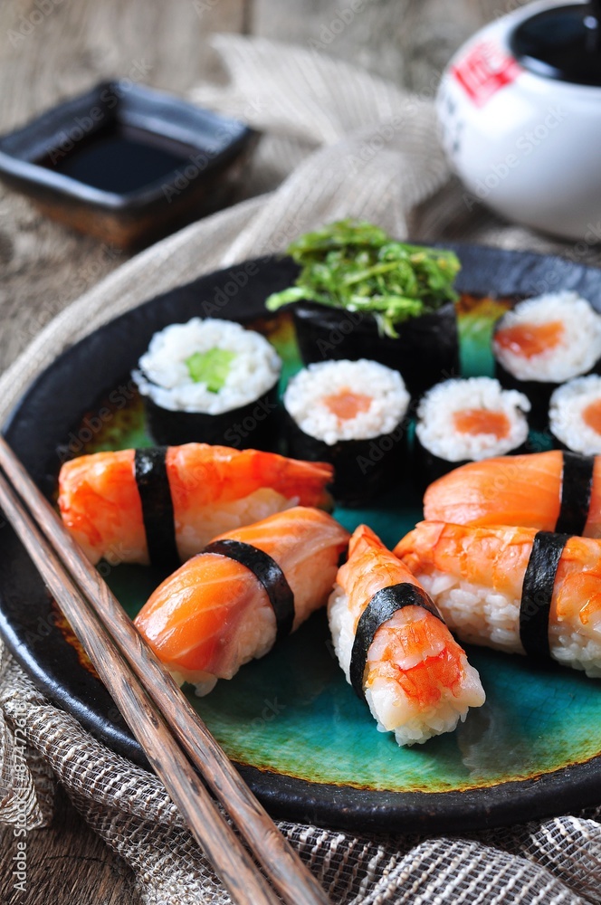 homemade sushi with wild salmon, shrimp, cucumber and seaweed. selective focus homemade sushi with wild salmon, shrimp, cucumber and seaweed. selective focus