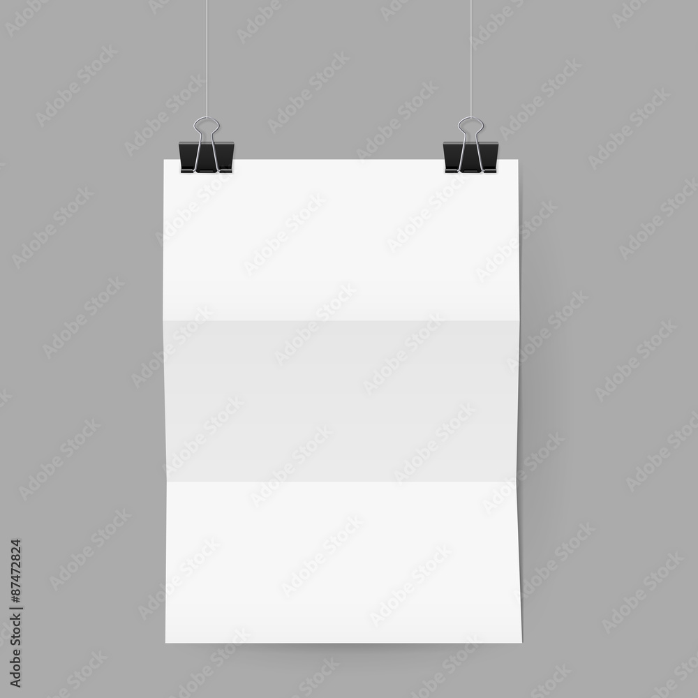 Sheet of paper folded in three hanging on paper clips Sheet of paper folded in three hanging on paper clips