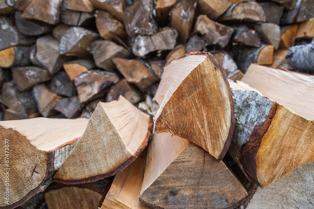 Dry logs stacked in a pile in the garden Dry logs stacked in a pile in the garden