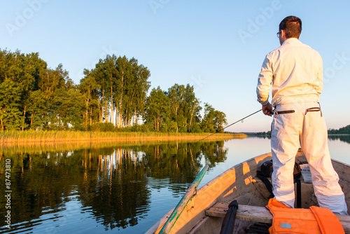 fisherman in the boat on the lake