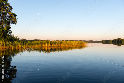 Fototapeta Naklejka Na Ścianę i Meble -  symmetric reflections on calm lake