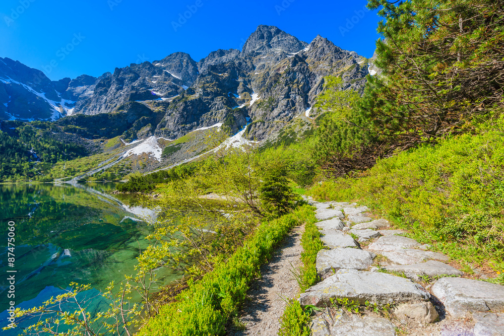 Fototapeta premium Path along beautiful green water Morskie Oko lake, Tatra Mountains, Poland