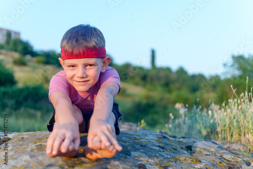 Fototapeta Naklejka Na Ścianę i Meble -  Little boy working out