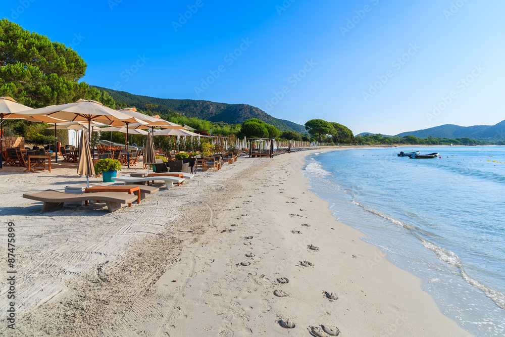 Sunbeds on sandy Palombaggia beach, Corsica island, France