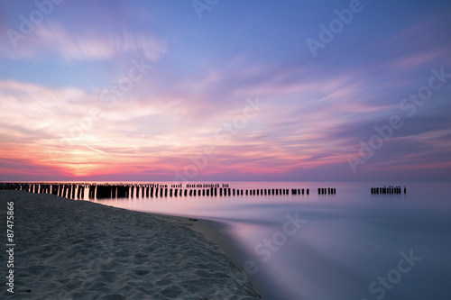Sunset and breakwaters on the Baltic Sea.  Long exposure #87475866