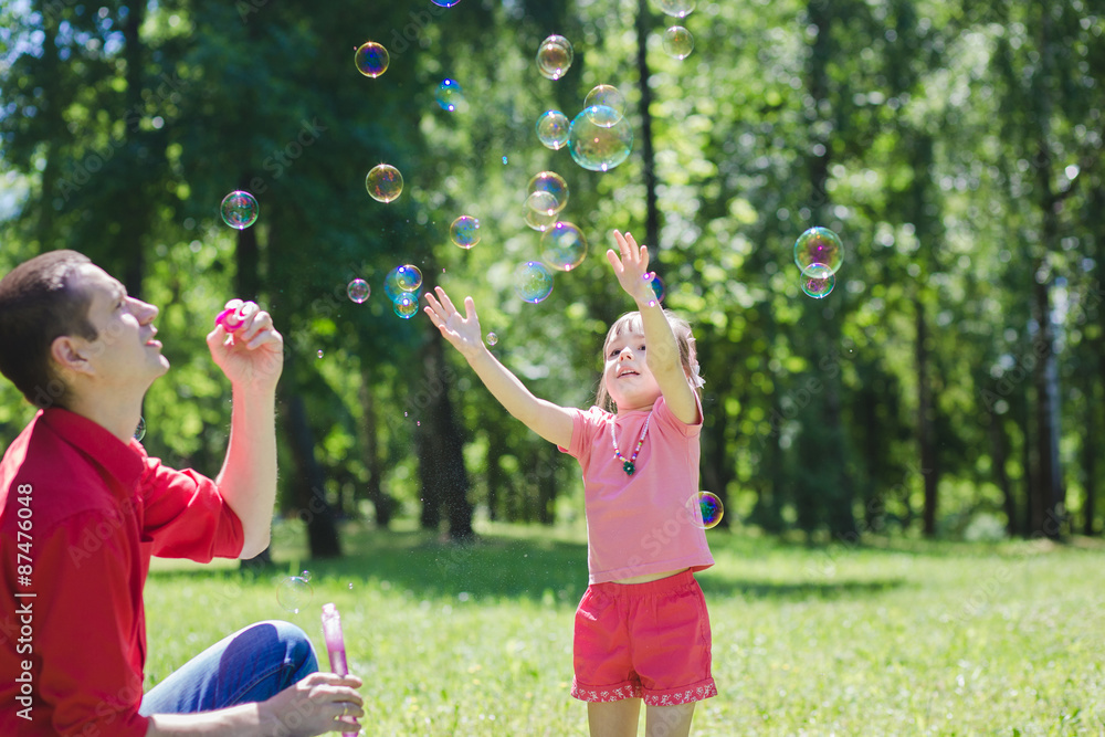 Dad and his daughter are making bubbles Dad and his daughter are making bubbles