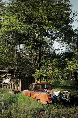 SURATTHANI, THAILAND - JUNE 4, 2014:Old Wrecked Car in farmland,