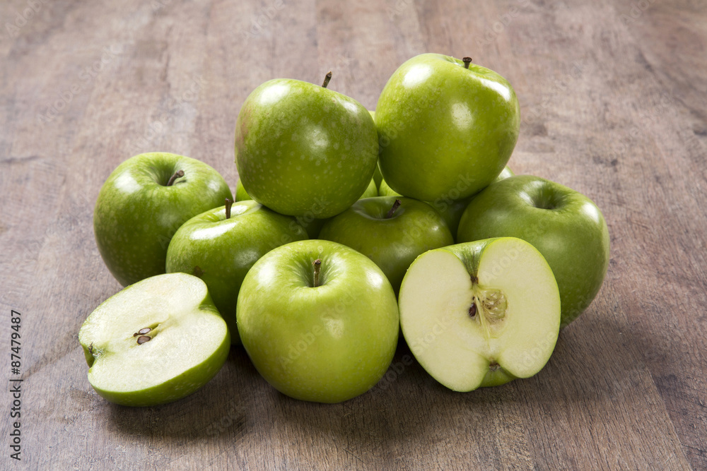 Some green apples on a wooden table Some green apples on a wooden table