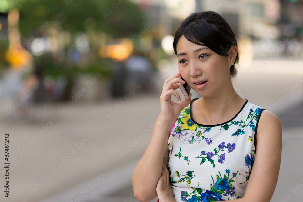 Young Asian woman talking on cell phone