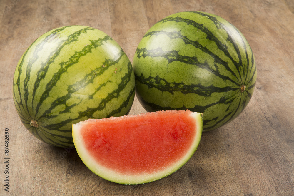 slices of watermelon on wooden table slices of watermelon on wooden table