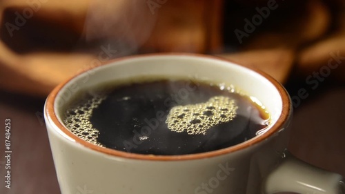 Pouring a cup of hot steaming coffee closeup
