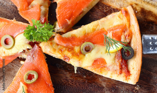 Salmon Pizza is cut into ready to eat. photo