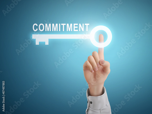 male hand pressing commitment key button