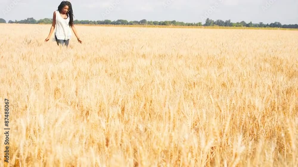 Beautiful Black Woman Running through a Wheat Field