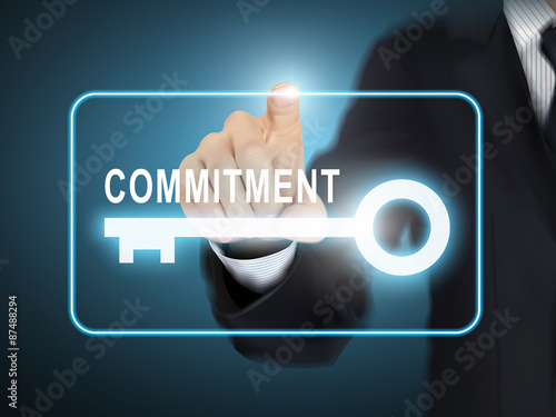 male hand pressing commitment key button