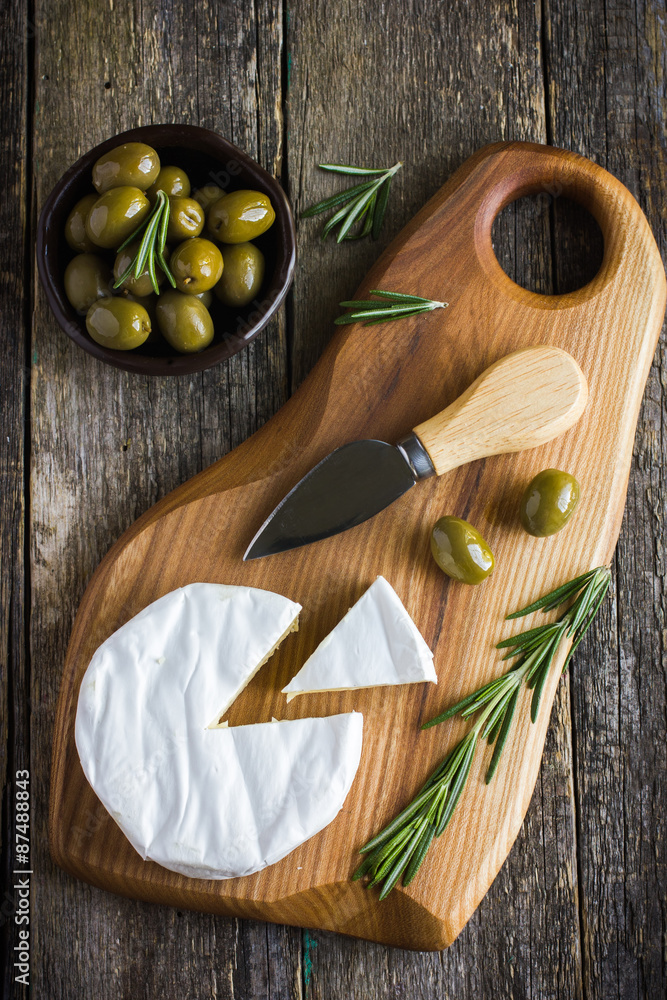 camembert cheese with rosemary and olives camembert cheese with rosemary and olives