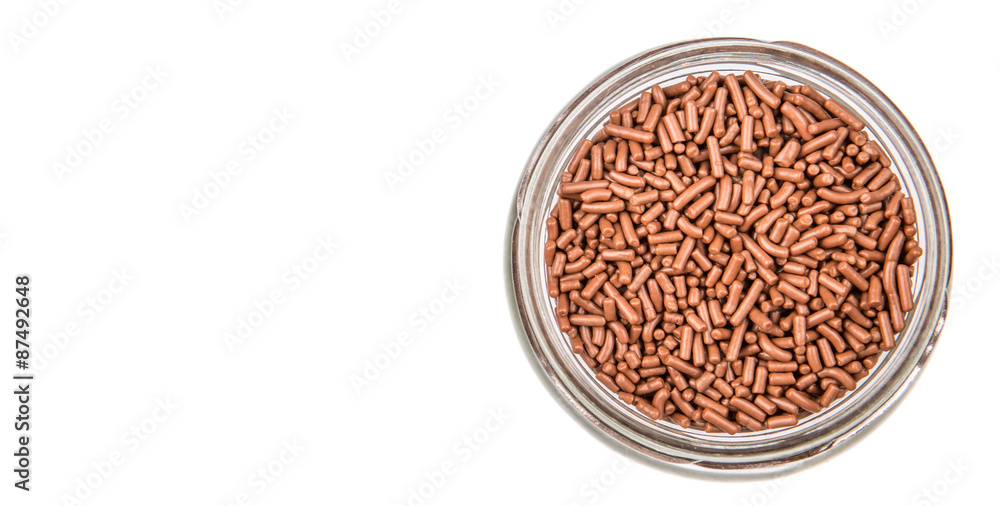 Chocolate sprinkle confetti in a mason jar over white background Chocolate sprinkle confetti in a mason jar over white background
