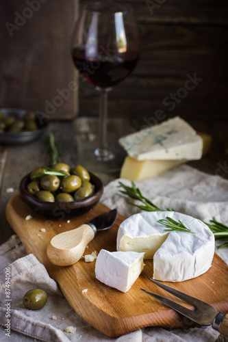 camembert cheese with rosemary and olives