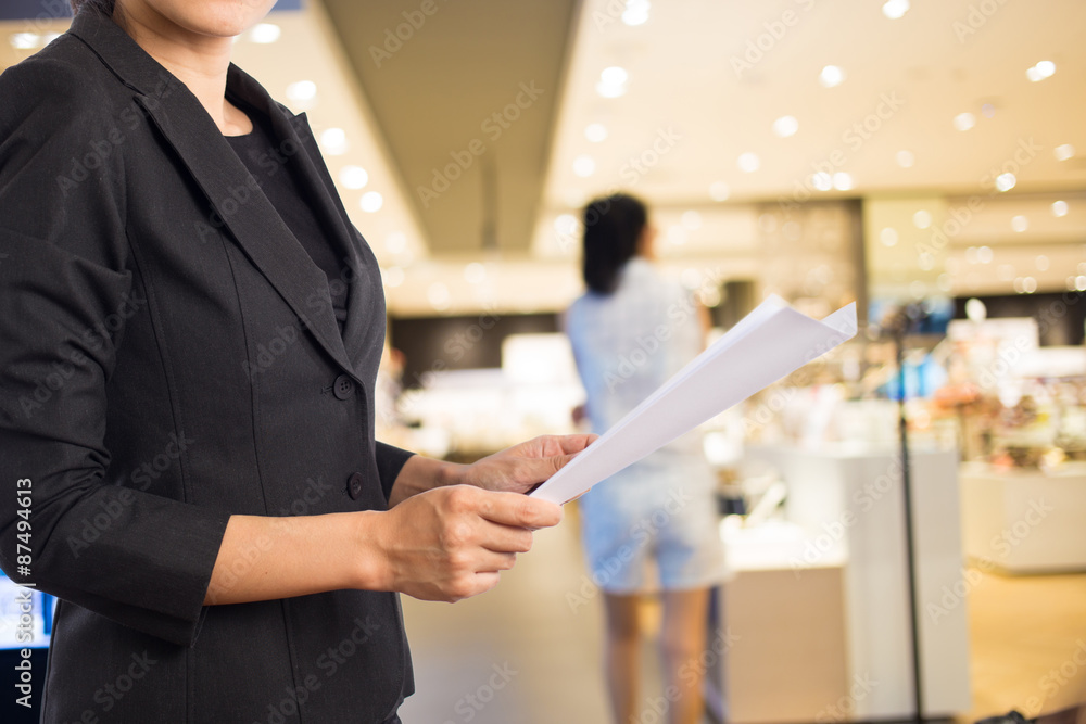 Businesswoman reading a business document. Businesswoman reading a business document.
