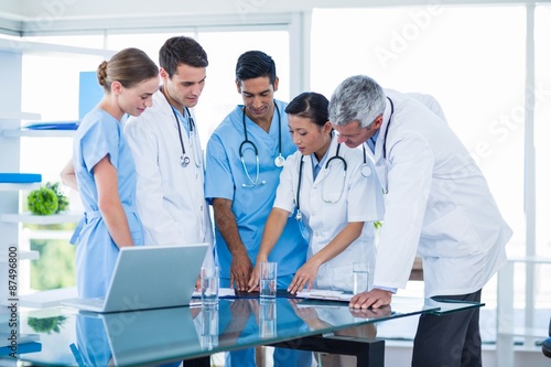 Doctors and nurses discussing together photo