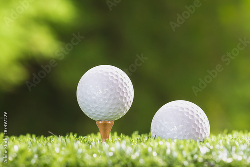 Golf ball on a tee peg and Golf ball on grass,