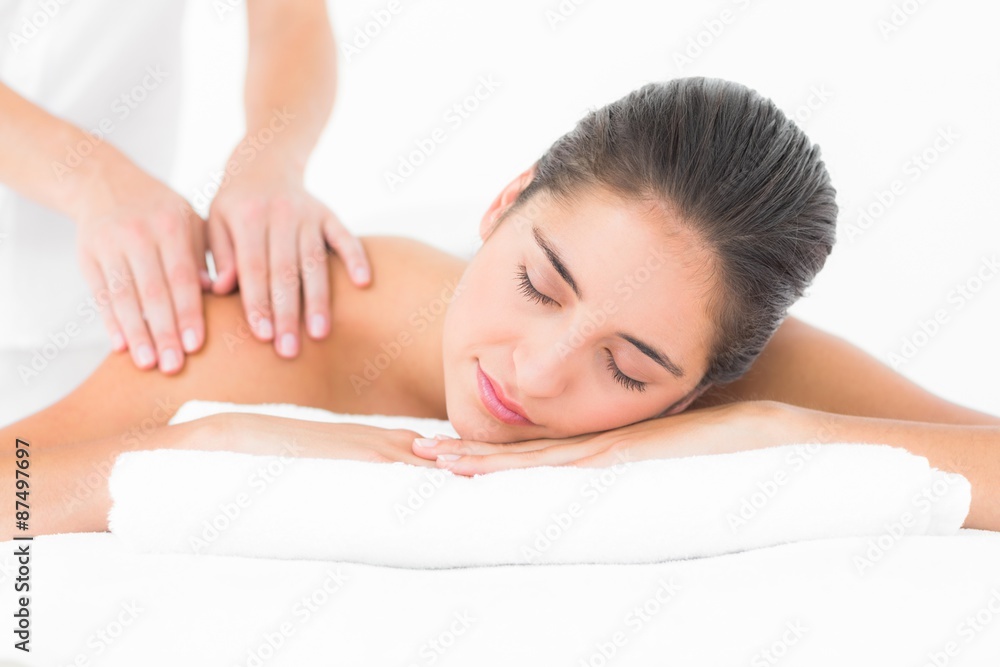 Attractive woman receiving shoulder massage at spa center Attractive woman receiving shoulder massage at spa center