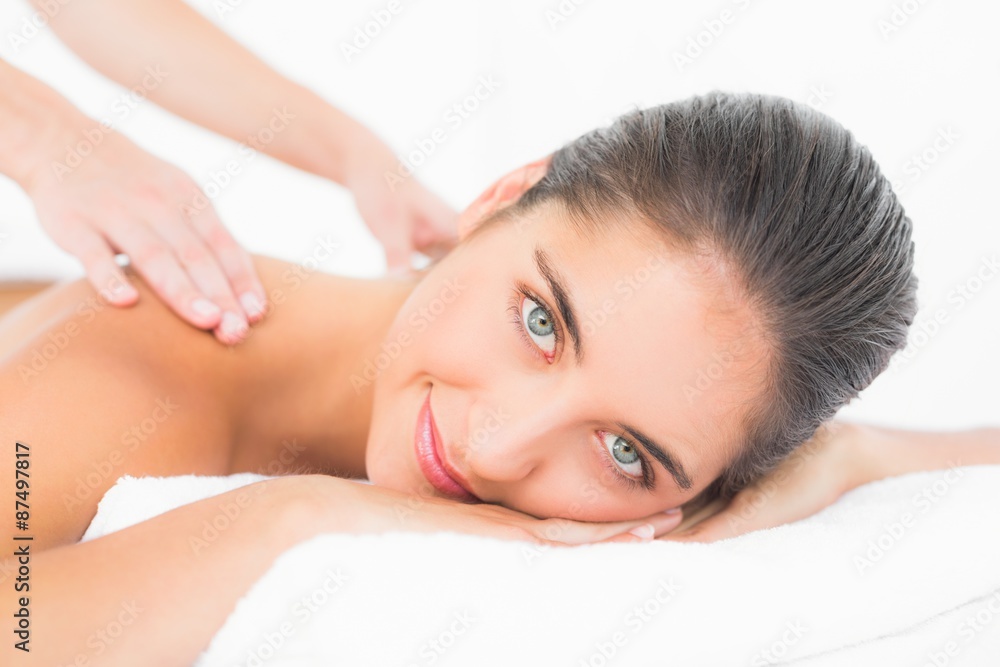 Attractive woman receiving back massage at spa center Attractive woman receiving back massage at spa center