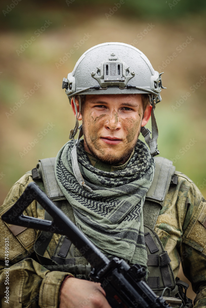 Fototapeta premium Portrait of a ranger in the battlefield with a gun