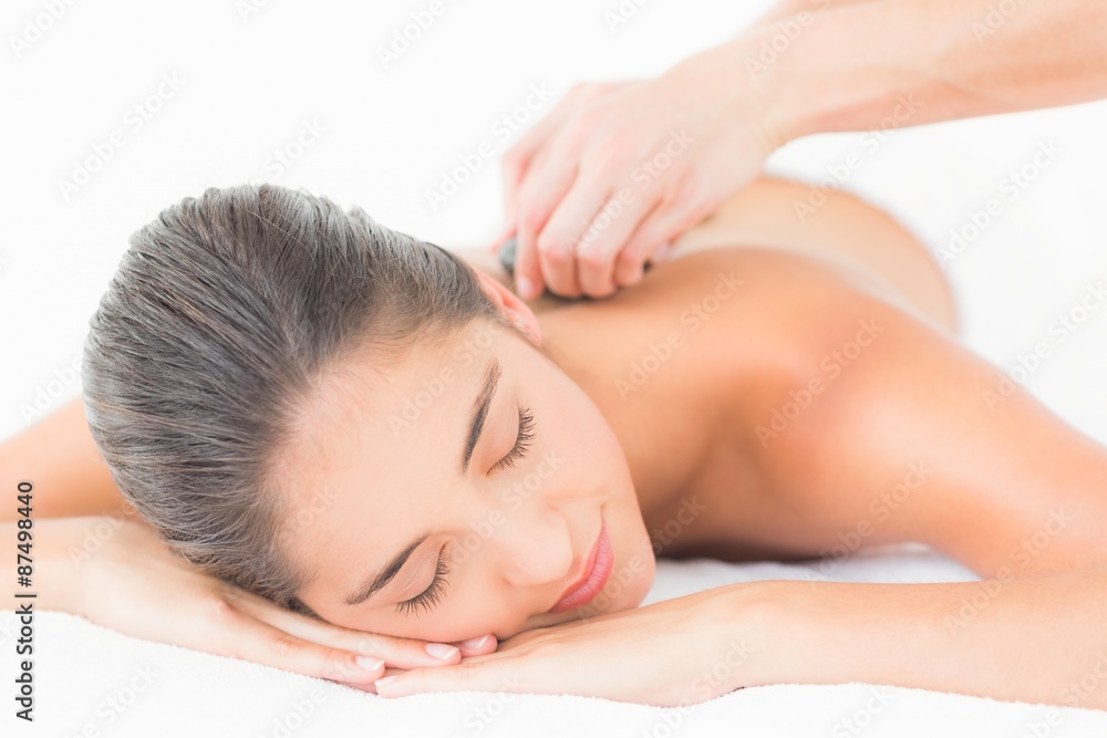 Beautiful brunette enjoying a hot stone massage Beautiful brunette enjoying a hot stone massage