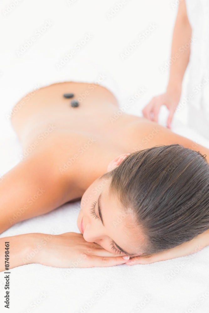 Beautiful brunette enjoying a hot stone massage Beautiful brunette enjoying a hot stone massage