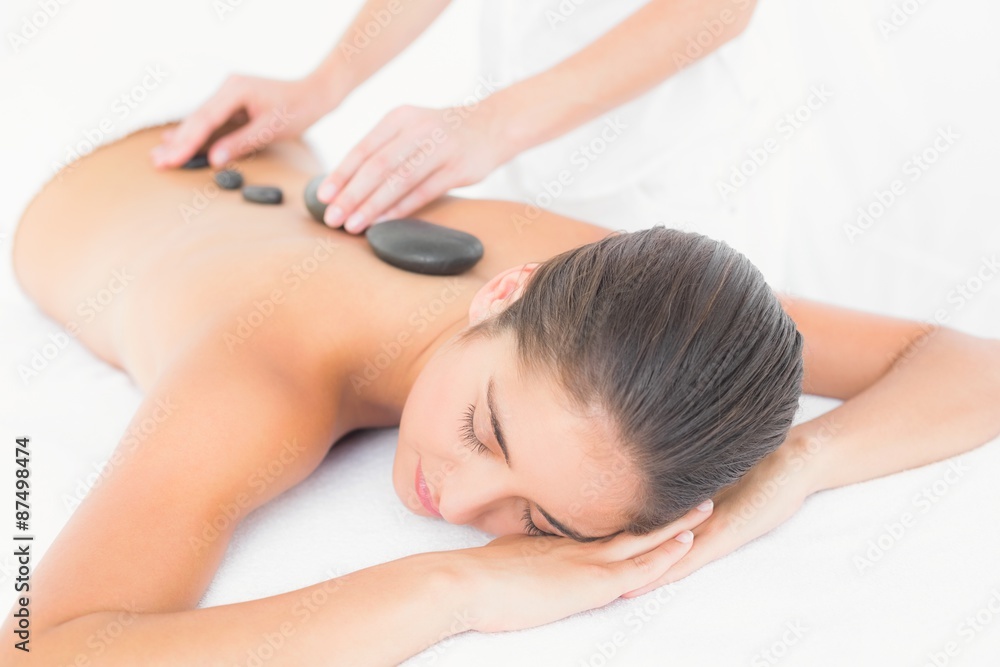 Beautiful brunette enjoying a hot stone massage Beautiful brunette enjoying a hot stone massage