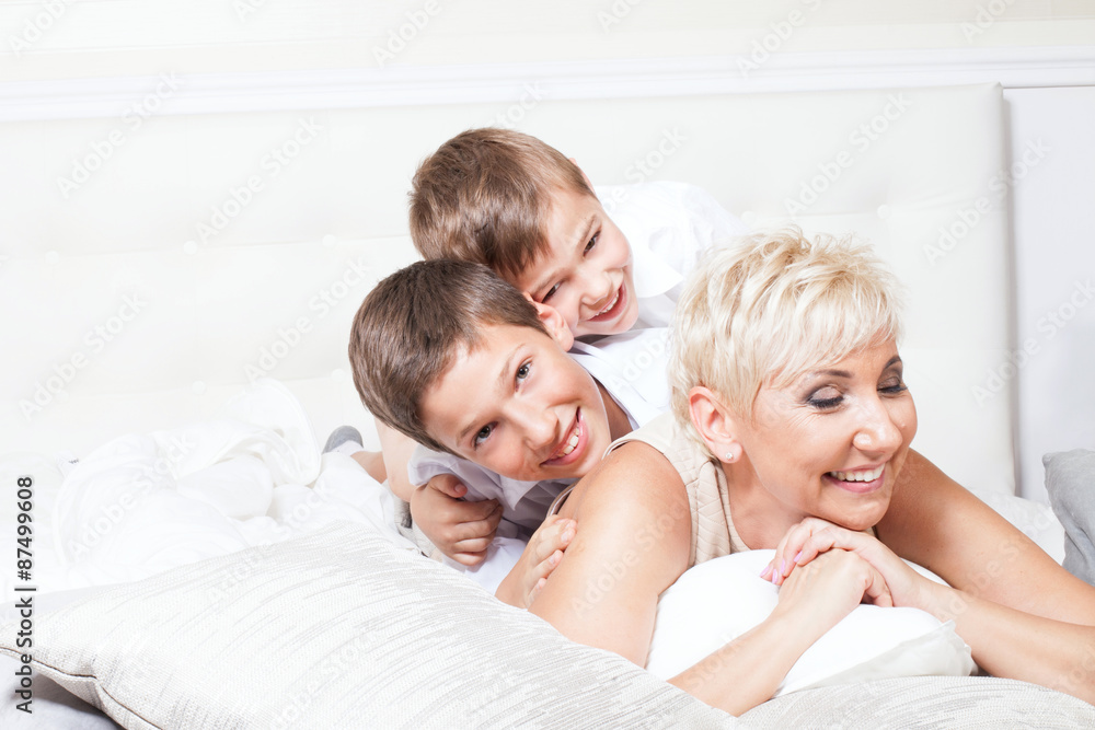 Family portrait, two brothers with beautiful blonde mum posing. Conceptual photo. Happy people. Family portrait, two brothers with beautiful blonde mum posing. Conceptual photo. Happy people.