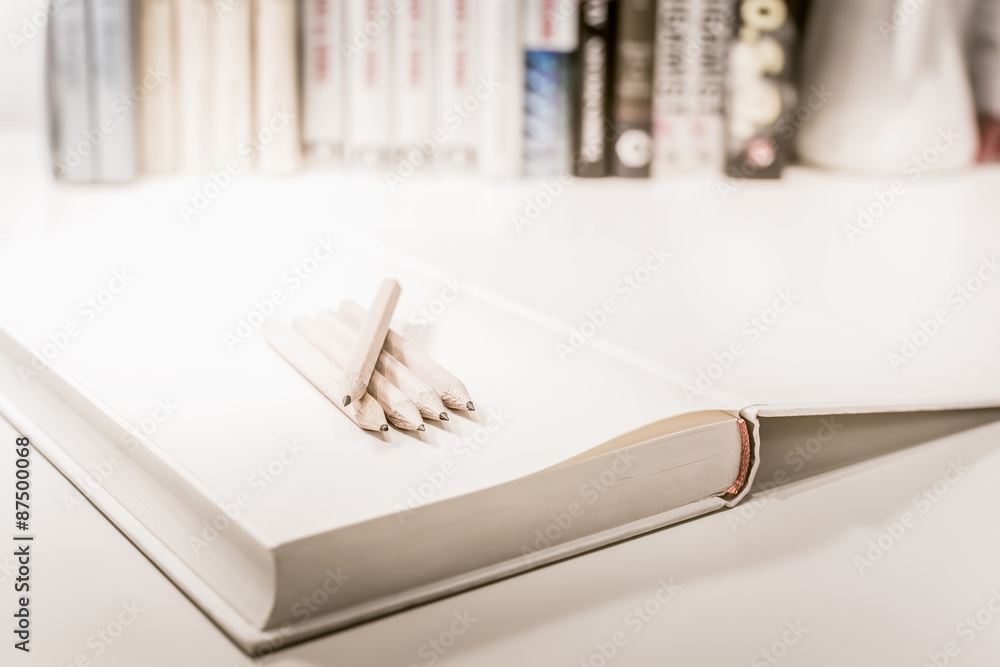 Penciles on a blank note book Penciles on a blank note book